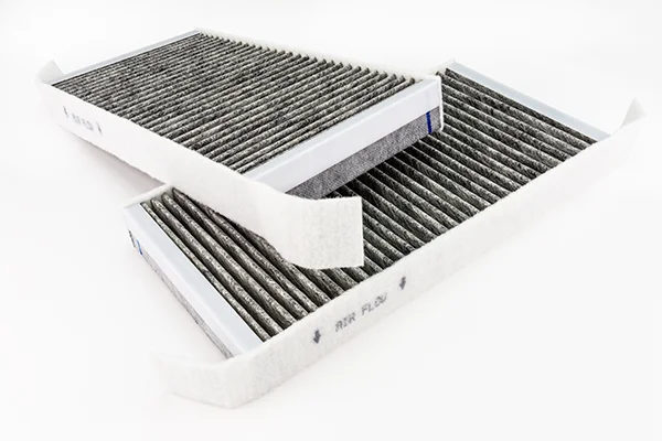 Two new cabin air filters on white background