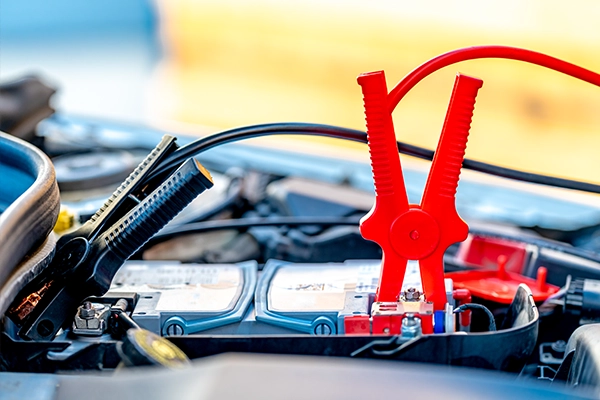 Jumper cables attached to car battery